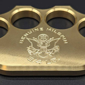 close-up brass knuckle engraved with MILSPIN logo