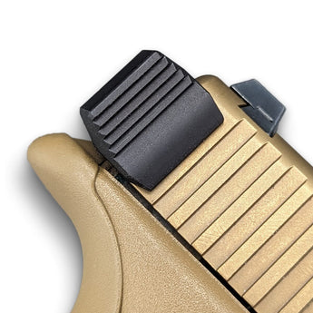 close-up of Glock slide racker on tan slide