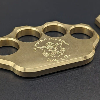 close-up view of American-made brass knuckles stamped with MILSPIN logo