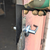 Man using CHAOS Bar firefighter door entry tool to open door